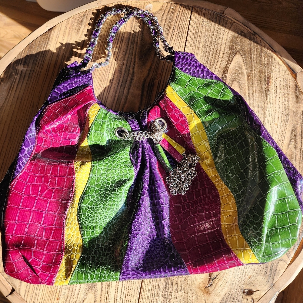 Multi color bag with silver tone chain straps and dangling decorative accents